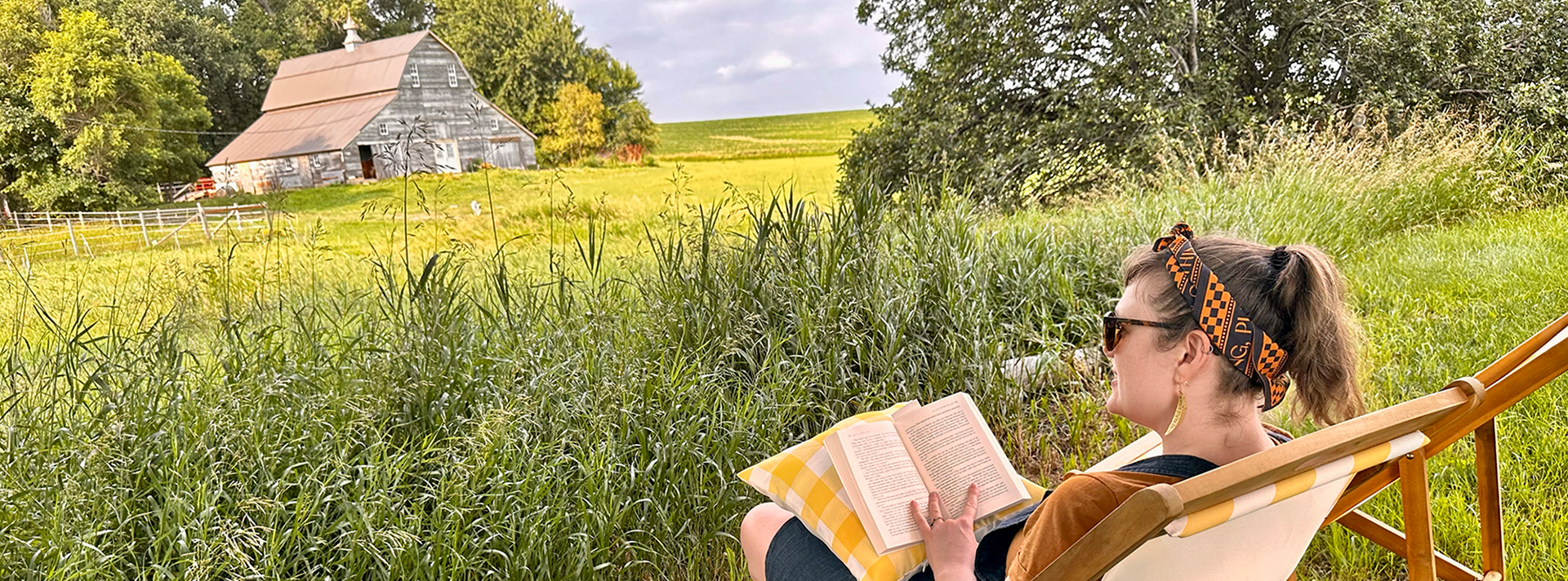 A Chicken Coop Artist In Residence reading outside at Villekulla Farm