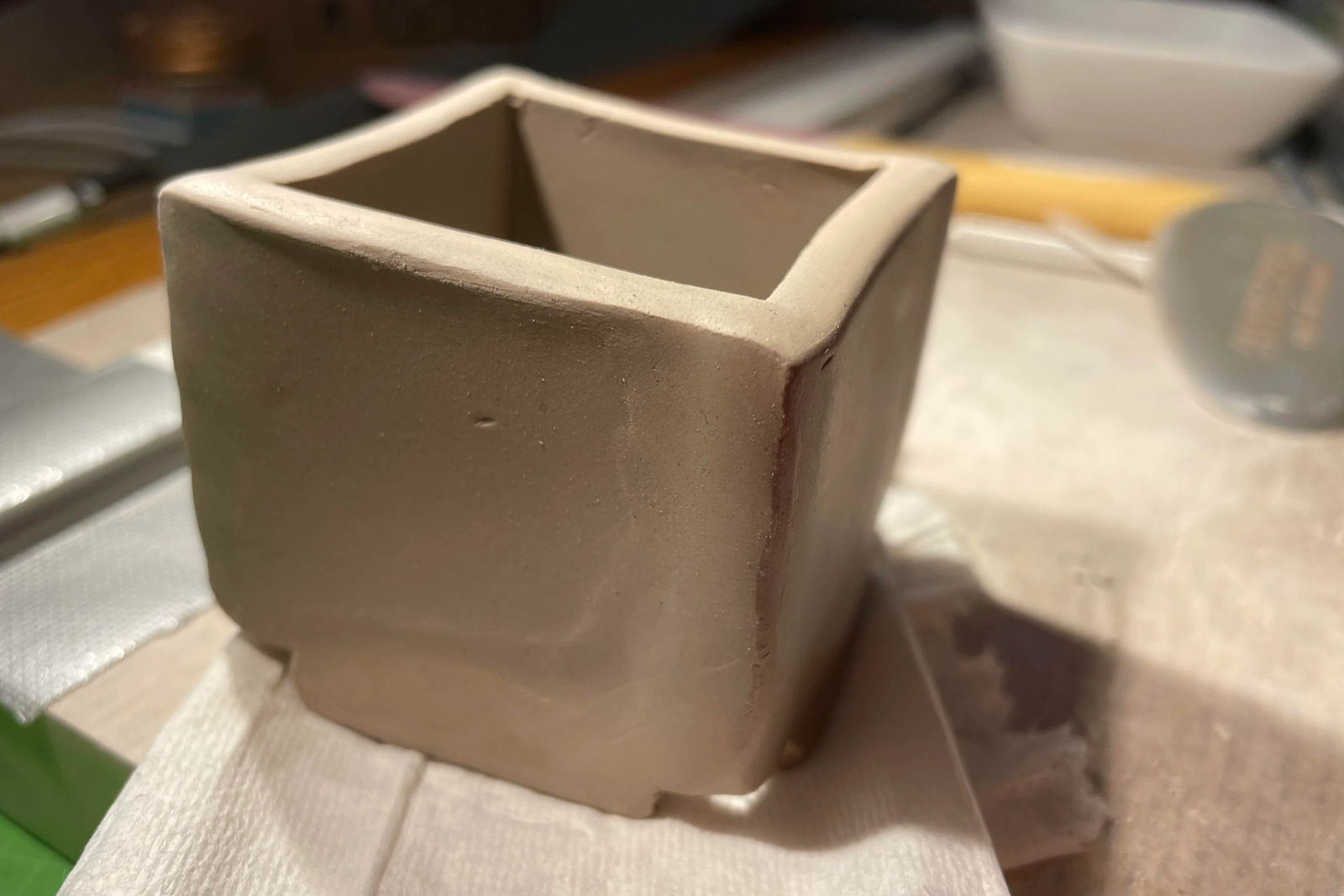 Ceramic Slab Planter Happenings a simple square clay planter sits on a table