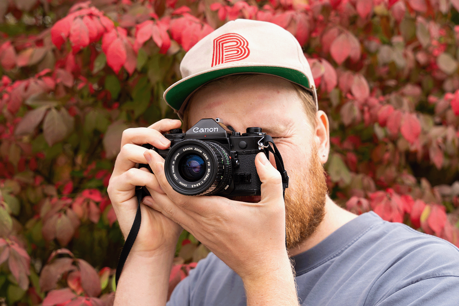 Intro To Film Camera Happenings A Close up of someone composing a photo with a film camera