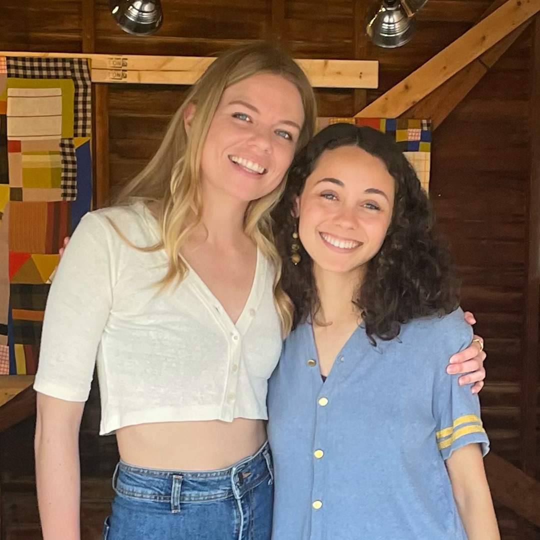 Populus Fund Grantees Joelle a biracial woman with a light skin tone and curly dark brown hair and Shelby a white woman with blond hair embrace and smile at the camera